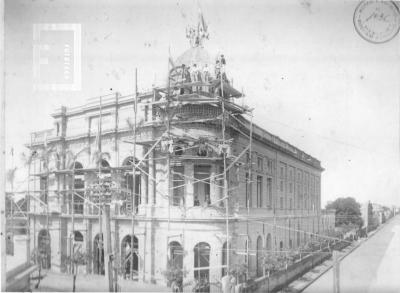 Teatro en construcción con andamios y obreros